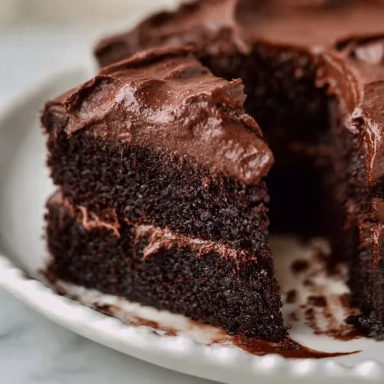 Gluten free dairy free chocolate cake topped with chocolate frosting